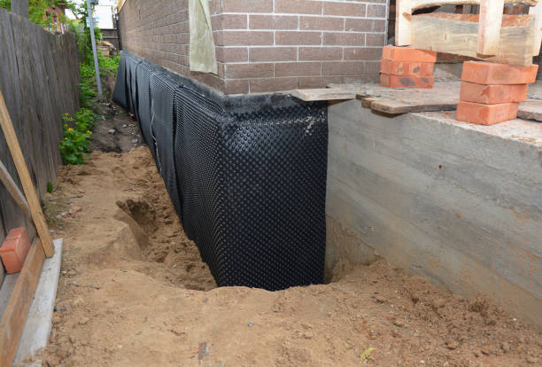 SJ Waterproofing Pros technician performing targeted Wet Basement Repair assessment in Johnstown, NY